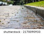 Water running over bricks after heavy rain storm in a city. Storm runoff.