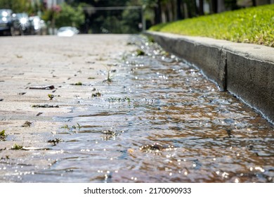 Water running over bricks after heavy rain storm in a city. Storm runoff. - Shutterstock ID 2170090933