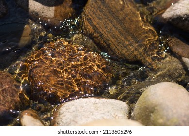 Water Running Over Rocks In Sunshine