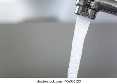 Water Running From A Tap Into A Kitchen Sink