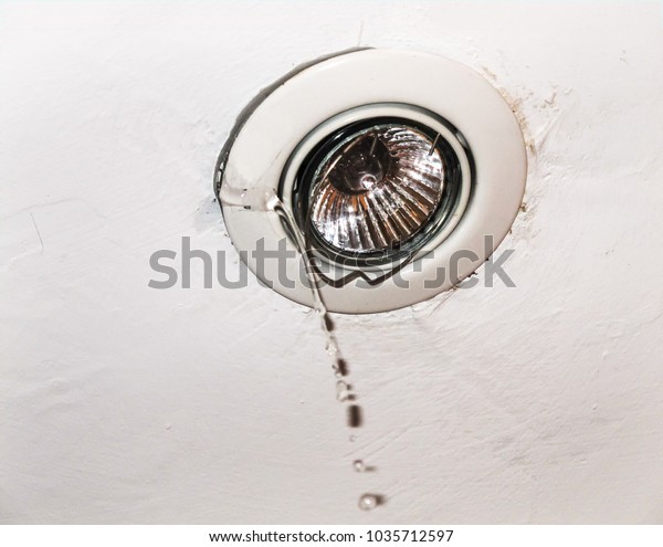 Water Running Through Electric Ceiling Light Stock Photo
