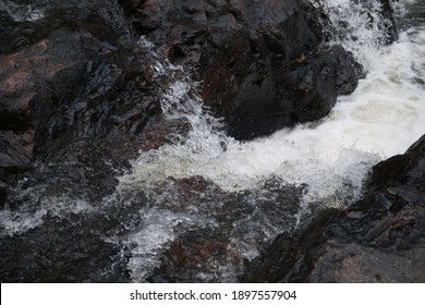 Water Running Through Rocks And Splashing