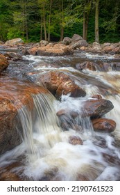 Water Rushing Over Rocks Along River Rapids In Forest