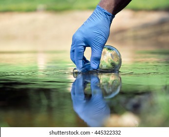 Water Sample. Hand In Glove Collects Water To Explore. Concept - Water Purity Analysis, Environment, Ecology. Water Testing For Infections, Permission To Swim