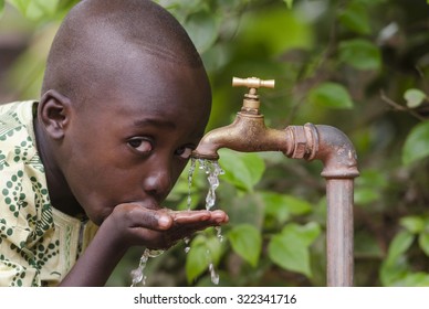 Water scarcity in the world symbol. African boy begging for water. In places like sub-Saharan Africa, time lost to gather water and suffering from water-borne diseases is limiting people's lives.