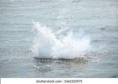 Water And Smoke Exploding From An Underwater Demolition, In A Cannon Ball Concept