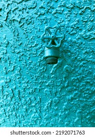 Water Spigot Mounted In Stucco Wall. Monochromatic Green