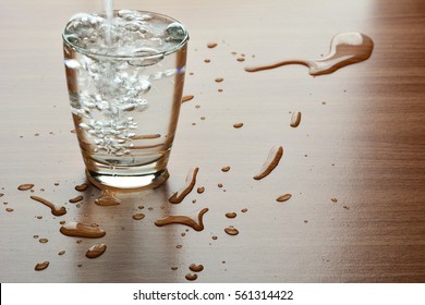 Water Spill Out Of Water Glass And Sloppy On Wood Table 