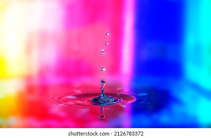 Water splash against multicolor background