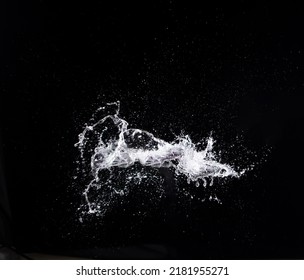 Water splash in air drop over black background, studio lighting high speed. water splashing throw in wind air and freeze stop with flash to see droplet texture for filter and layer - Powered by Shutterstock