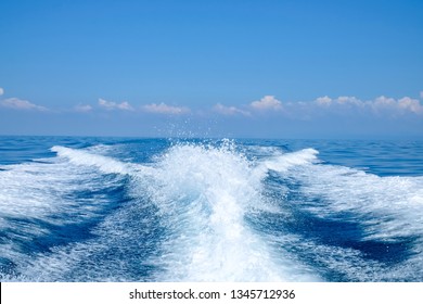 Water splash behind the ship or wake of speed boat in the ocean with beautiful blue sky and white clouds use for holiday and transportation background