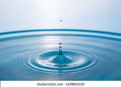 Water splash close-up. Crown of blue water. Water drop. Frozen splashes.