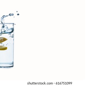 Water. Splash In A Glass Of Pure Water With A Lemon Isolated On A White Background