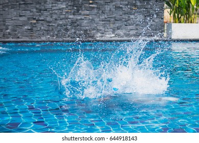 Water Splash From Kid Jump To The Pool