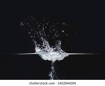 Water Splash On Liquid Surface Isolated On Black Background, Close Up View. Water Bubbles In Air And Underwater. Abstract Background For Overlays Design, Screen Blending Mode Layer