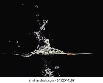Water Splash, Rippling Surface, Water Bubbles In Air And Underwater, Isolated On Black Background, Close Up View. Abstract Black Background For Overlays Design, Screen Blending Mode Layer