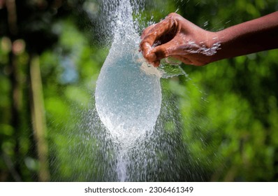 Water splash in slow motion from a balloon with hand punch