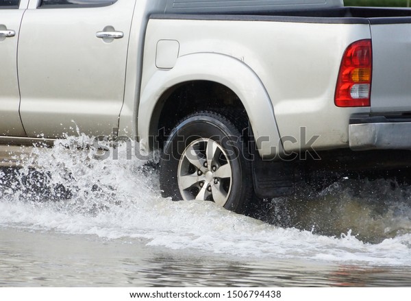Water Splashed by a car\
running through a flooded road after heavy rain                    \
         