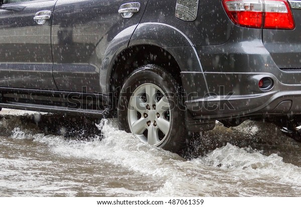 Water Splashed by a car running through\
a flooded road after heavy rain, blurry movement\
