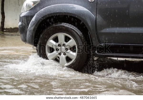 Water Splashed by a car running through\
a flooded road after heavy rain, blurry movement\
