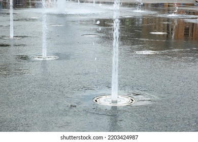 Water Splashes From Fountain. Natural Texture Of Only Water Of Fountain. High Waves Effect In Hot Summer With Copy Space. Water Sprays In Sunny Day Close-up.