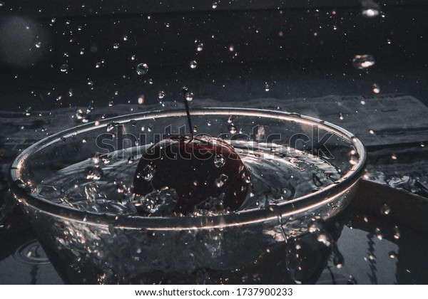 Water Splashing Of the bowl, while\
an apple is being is dropped into the bowl. it signifies the\
importance of washing fruits and veggies before consuming\
it.
