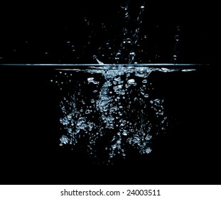 Water splashing forming air bubbles over a black background