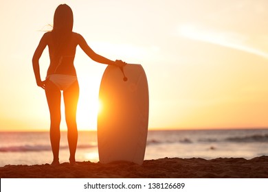 Water sport bodyboarding surfer woman on summer beach vacation holidays travel. Surfing girl holding bodyboard looking at ocean sea and sunshine. Beach bikini babe. Kaanapali beach, Maui, Hawaii.