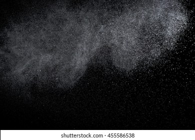 Water is sprayed randomly on a black background.