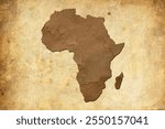 Water stain mark in the shape of the Africa continent map on a weathered brown leather parchment. Vintage history map of continent africa.