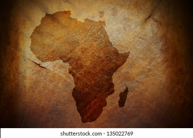 Water Stain Mark In The Shape Of The Africa Continent Map On A Weathered Brown Leather Parchment.