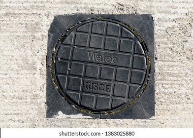 Water stopcock cover with Irish Gaelic word "Uisce" (Water) which caused controversy when used in Ballymena, Northern Ireland.