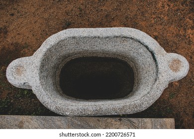 Water Storage Basin Made Of Stone,top View With Partially Filled Water.