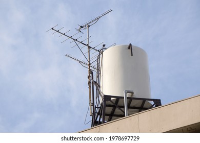 Water Storage Tank And Antenna TV On Top Of Roof