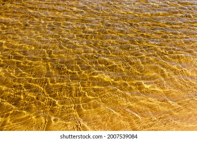 Water Of Stream Flows Through Sandy Bottom