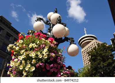 A Water Street Lamp And Hanging Basket In The Heart Of Vancouver's Gastown. Gastown Is The Touristy Heritage District Of Vancouver. British Columbia, Canada.