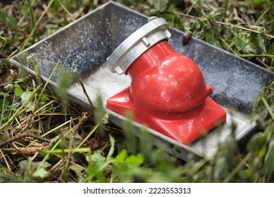 A Water Suction Nozzle For Shallow Water Stands In A Galvanized Tub During A Fire Brigade Exercise