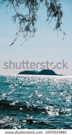 Water sun flare wallpaper close-up background texture. Sparkling sunlight on oceanic waves. Scintillate sea surface and evening summer rocky coastline.