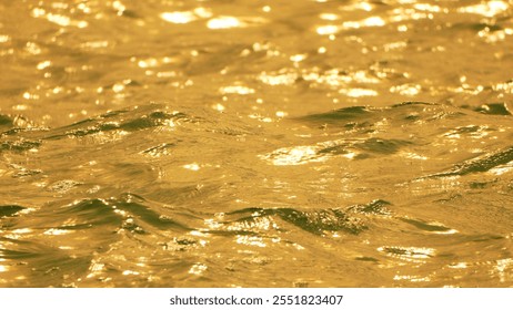 Water, Sunlight, Reflections - Close-up of shimmering water reflecting golden light. - Powered by Shutterstock