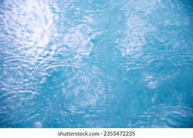 water surface in the pool with raindrops