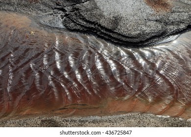 Water surface with ripples and sunrays reflections