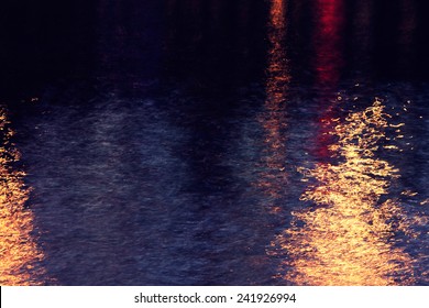 Water Surface Of A Town's River At Night