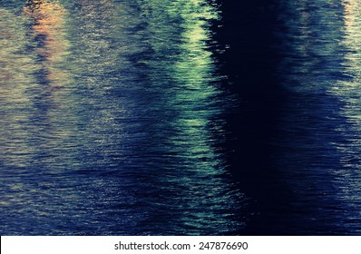 Water Surface Of A Town's River At Night