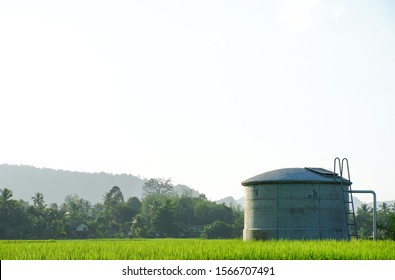 water tank in the field on rural property, oil tank, water irrigation metho...