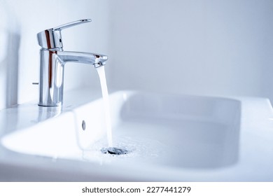 Water tap , faucet. Flow water in bathroom with sink. Modern clean house. Backround hygiene. - Powered by Shutterstock