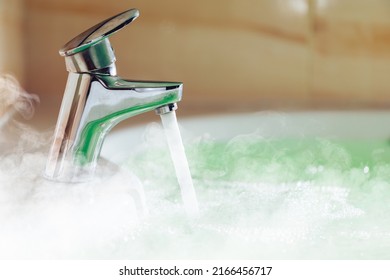 Water Tap Pouring Hot Water In A Bath Tub With Steam