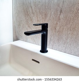 Water Tap With A Sink In The Kitchen. Black Water Faucet Bathroom. Closeup Of Water-supply Faucet Mixer For Water Isolated.