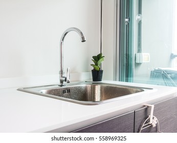 Water tap with sink in modern kitchen.