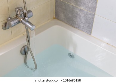 water tap with warm water and bathtub