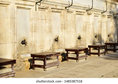 Water Taps And Wooden Seats Used For Islamic Ritual Washing Or Ablution At Süleymaniye Mosque (opened In 1558) In Istanbul, Turkey.